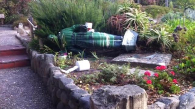 The statue Junipero Serra, tipped over and labeled 